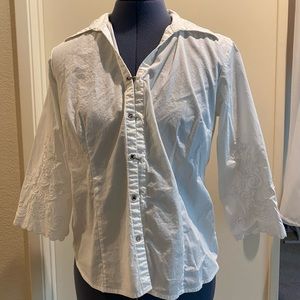 White button up top with embroidery on the sleeves